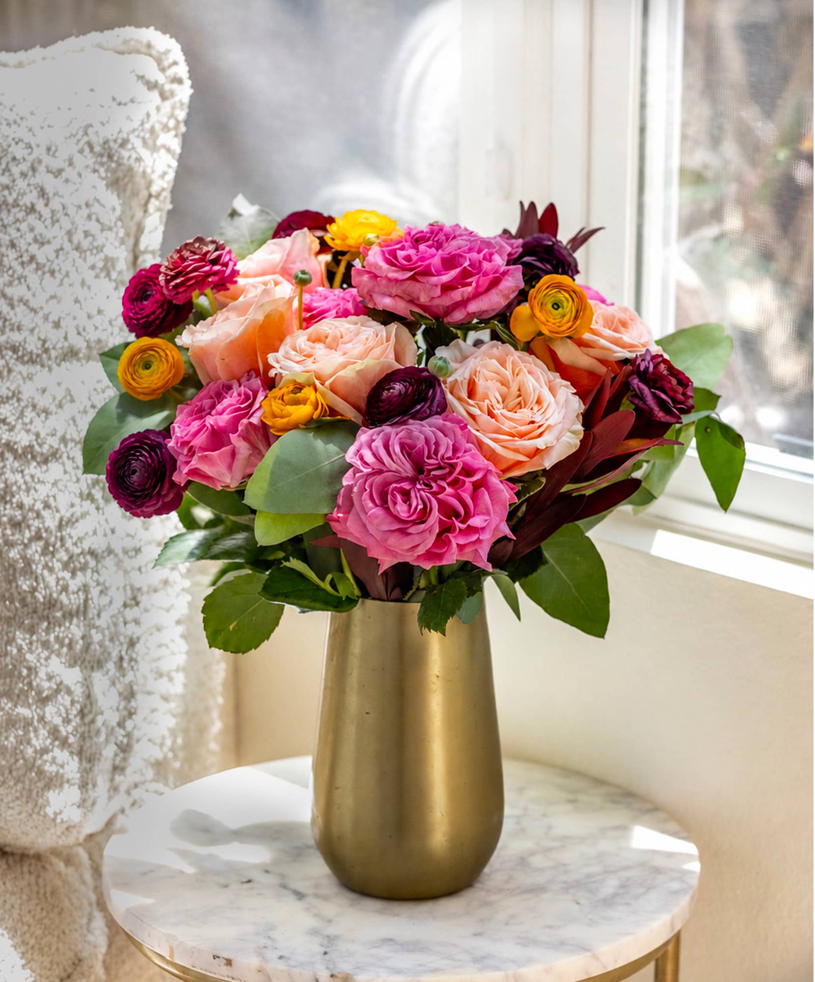 Vibrant bouquet featuring pink, orange, and purple roses, perfect for brightening any space.