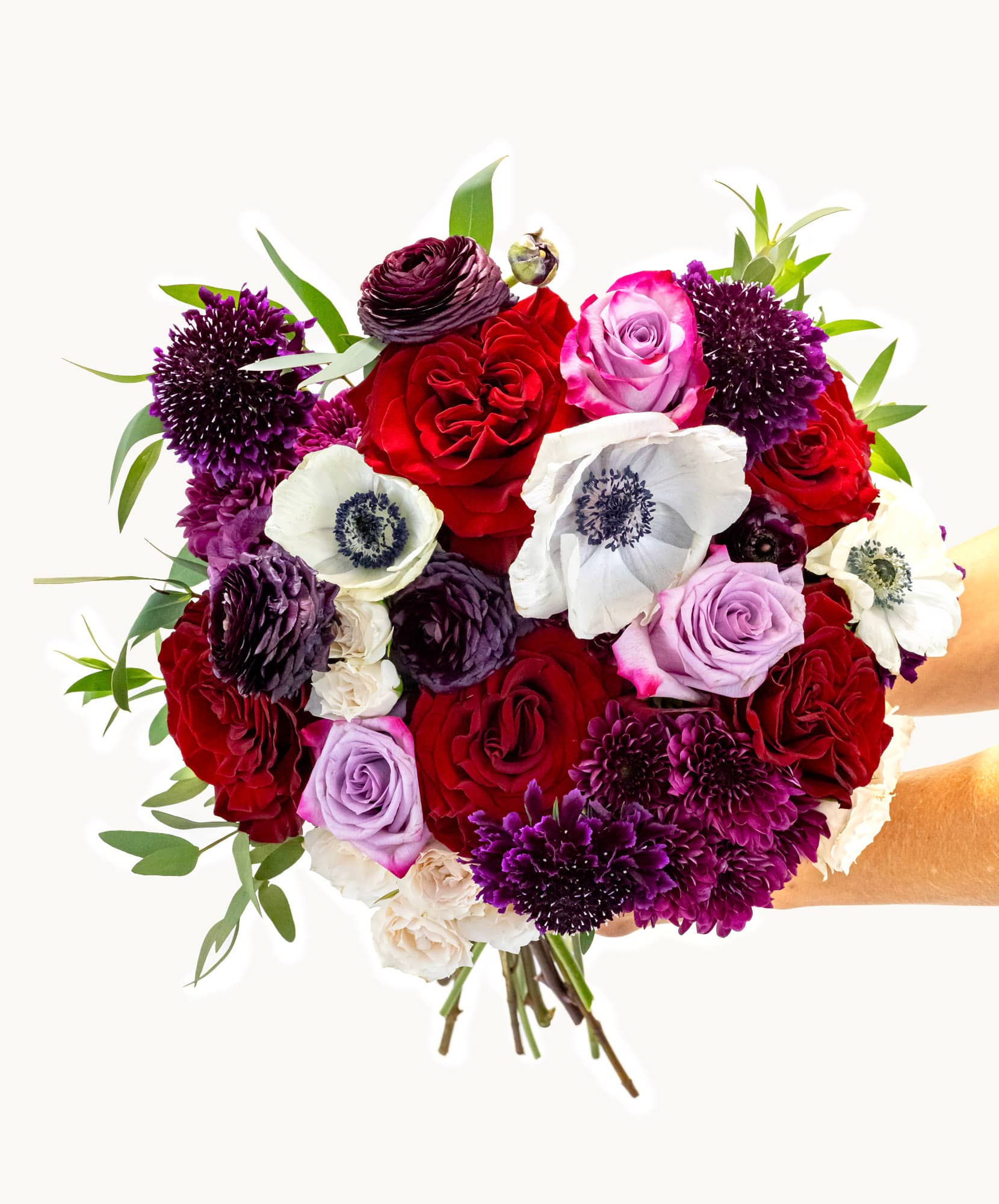 Vibrant bouquet featuring red and purple flowers, perfect for celebrations and gifts.